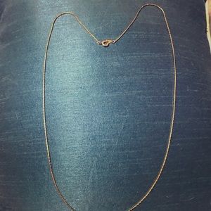 Mid-chest length goldtone thin chain